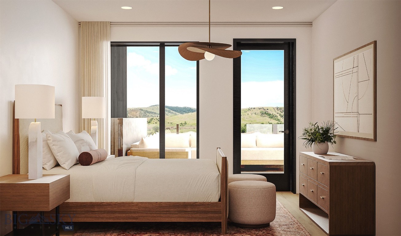 Furnished bedroom with a wood-framed bed and large windows overlooking rolling hills.