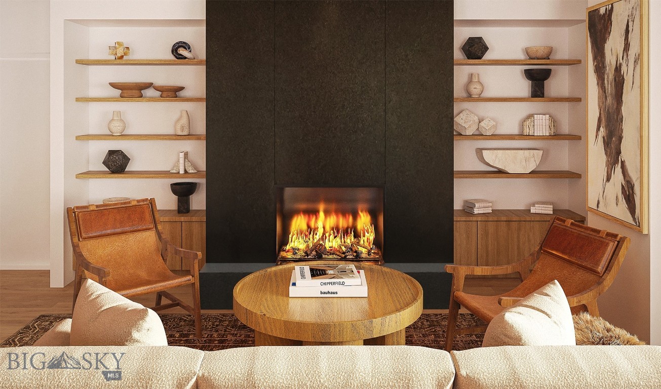 Living room with a dramatic black fireplace, built-in shelves, leather chairs, and a round wood coffee table.