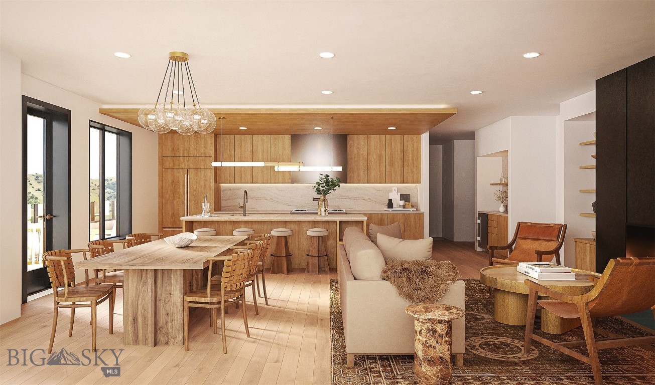 Open-plan kitchen and living area with warm wood finishes, a long dining table, and windows overlooking rolling hills.