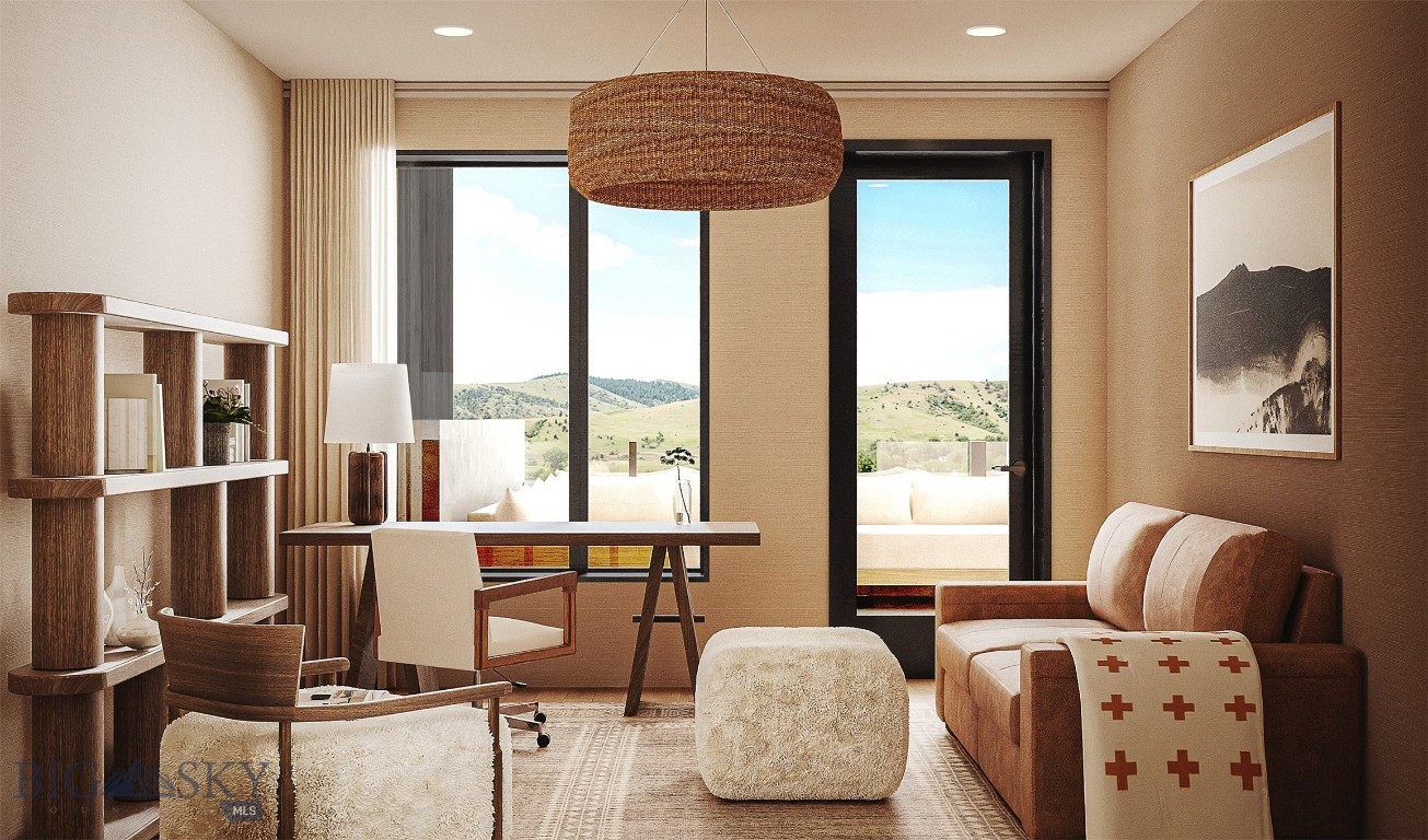 Staged living room with a tan sofa, desk, open shelving, and views of rolling hills.