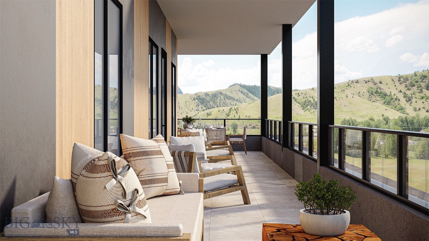Furnished covered balcony with lounge seating and mountain views.