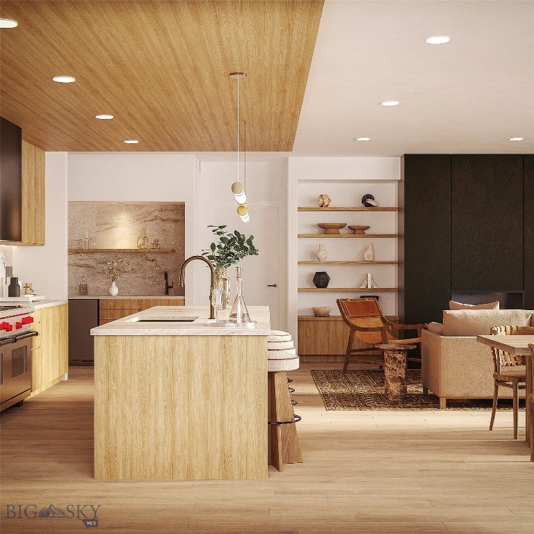 Open-plan kitchen and living area with a large wood-clad island and built-in display shelves.