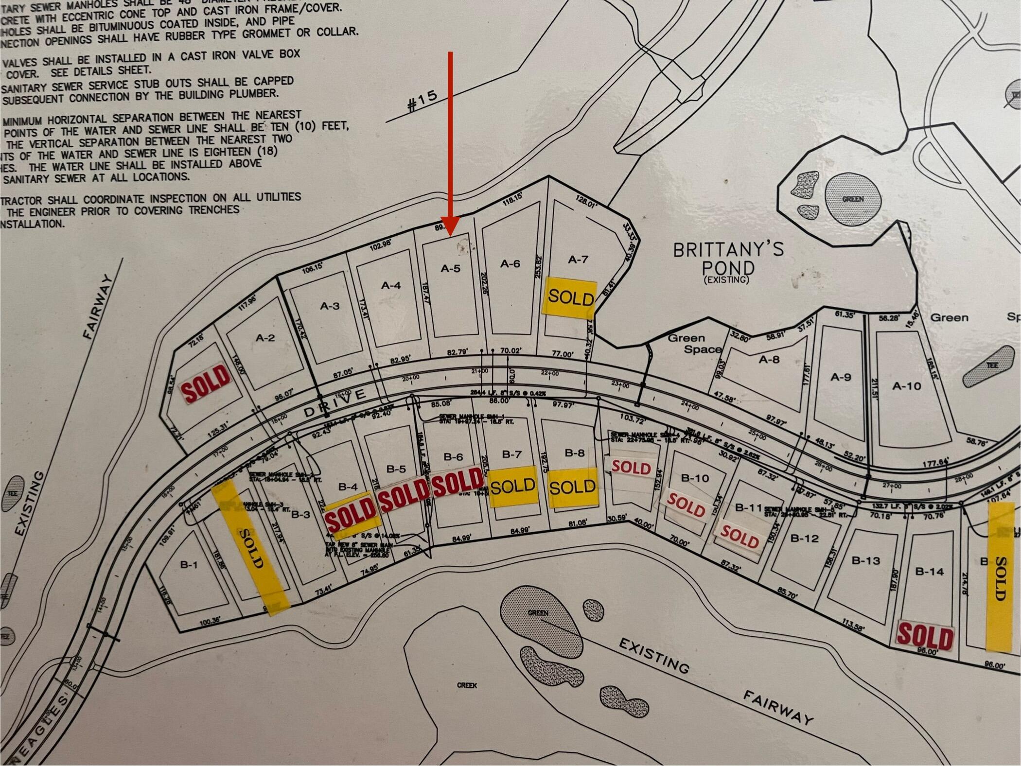 Subdivision plan with an arrow pointing to lot A-5 beside Brittany’s Pond and the fairway.