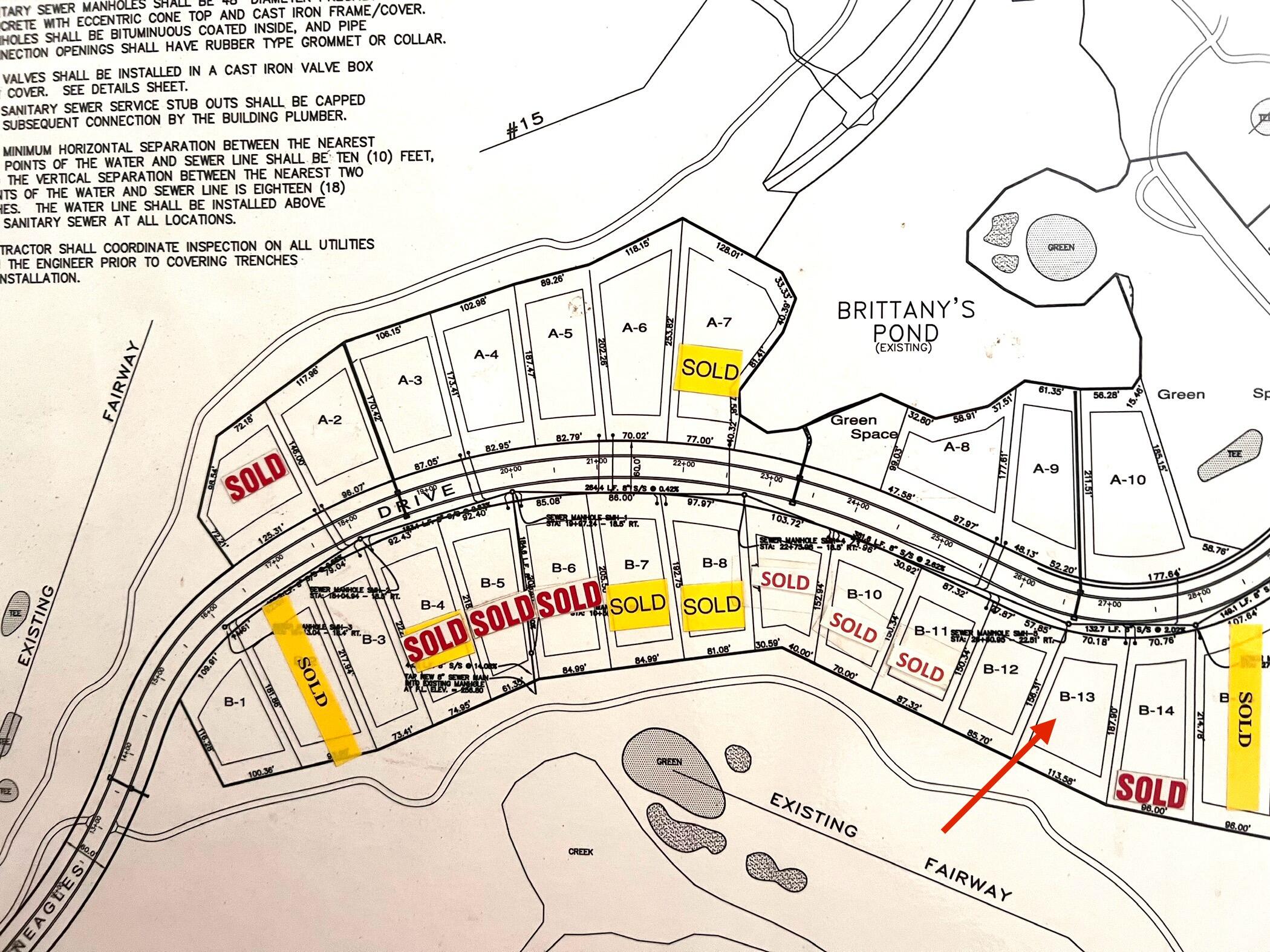 Subdivision plan highlighting lot B-13 with a red arrow among lots along Fairway Drive.