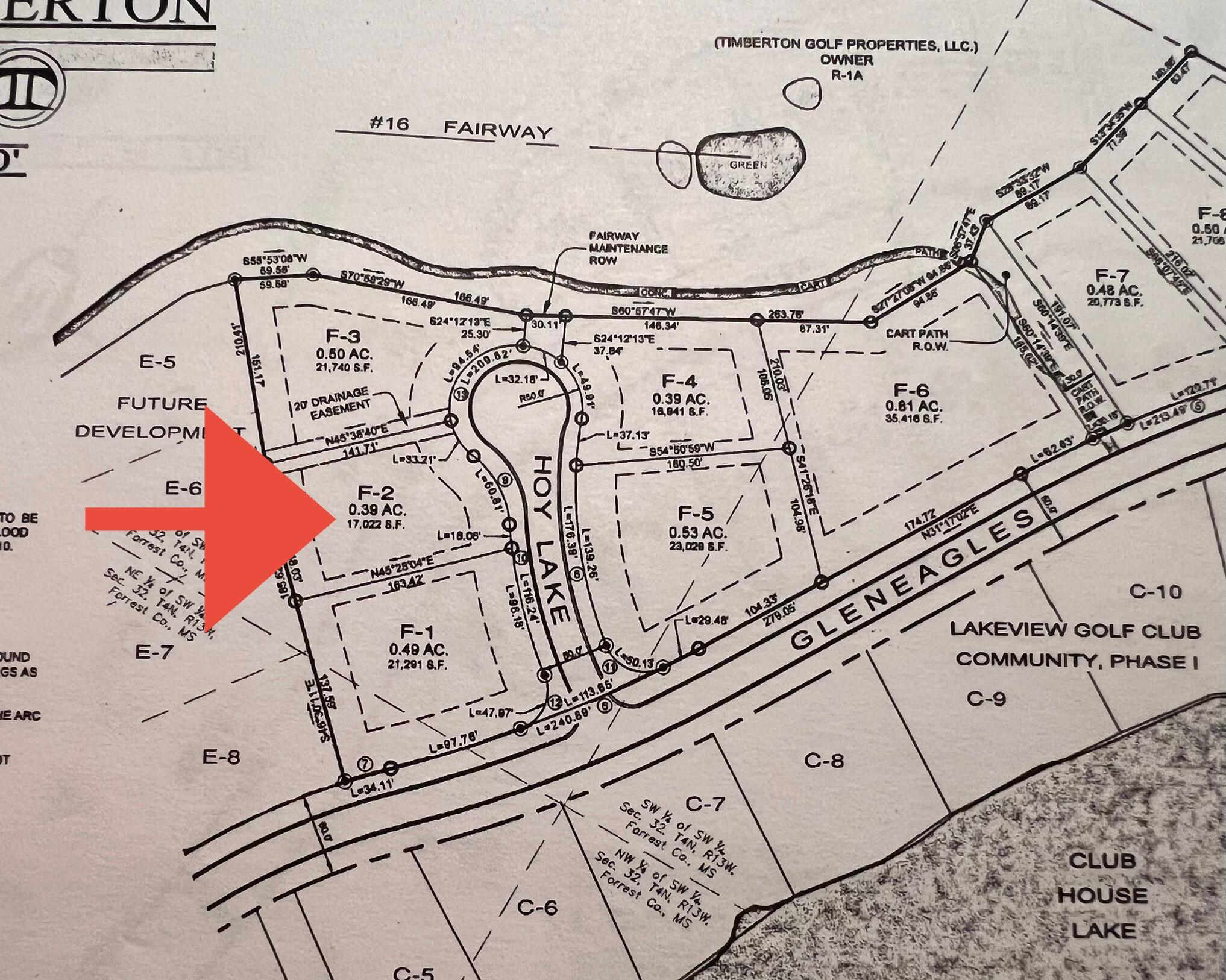 Plat map marking lot F-2 with a red arrow beside Holy Lake.