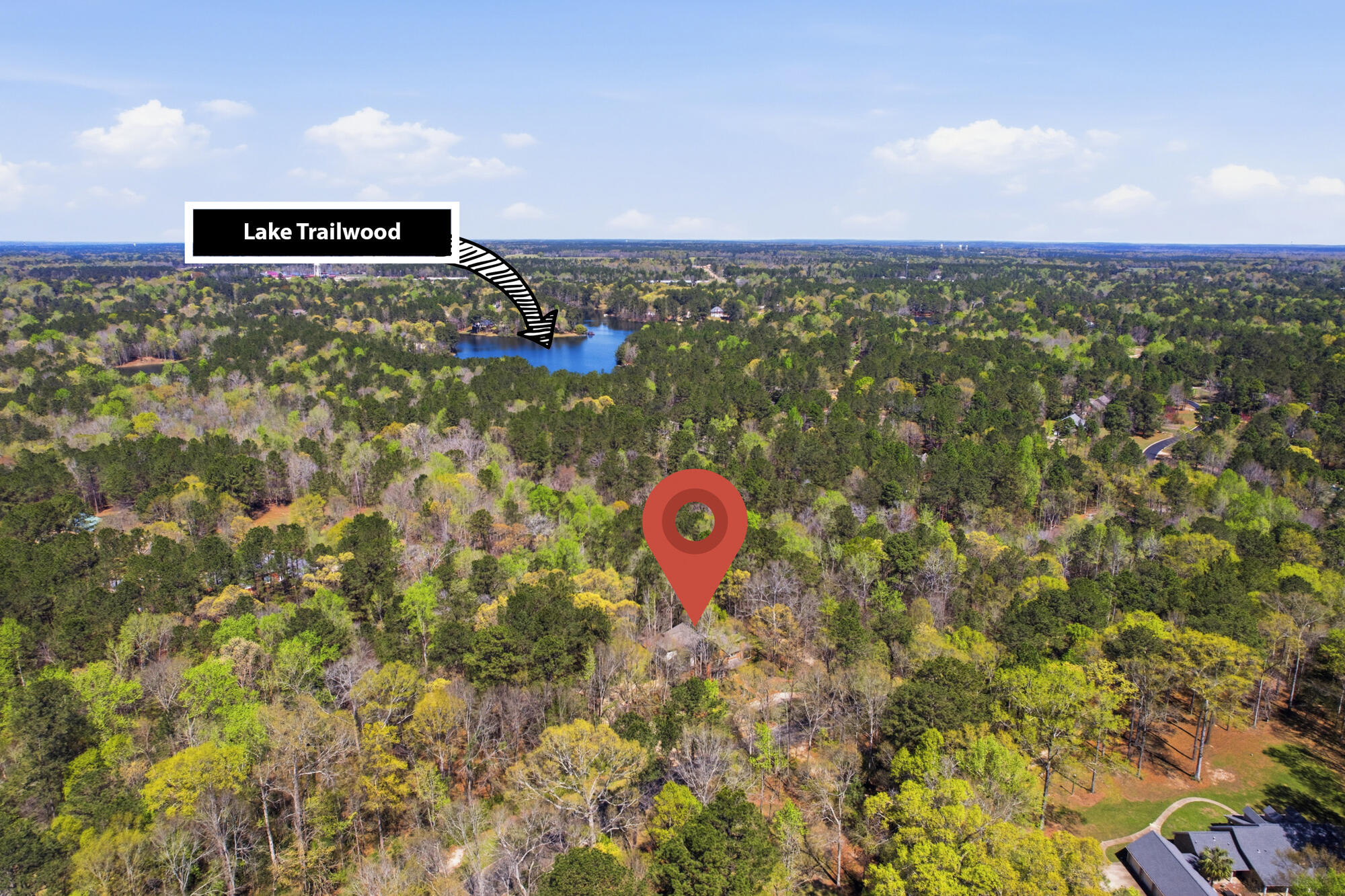 Aerial view of wooded property near Lake Trailwood, marked with a red location pin.