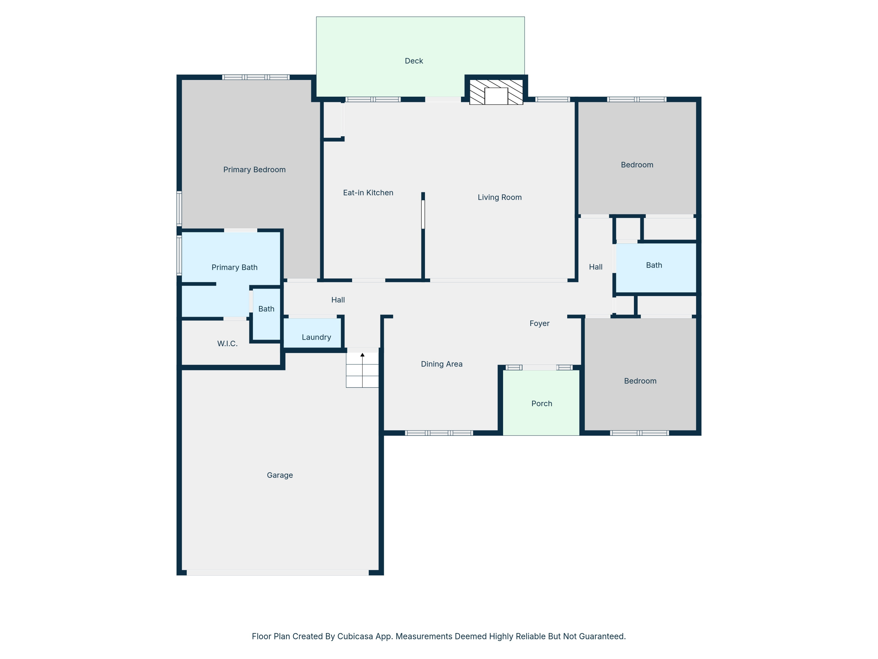 Floor plan showing three bedrooms, two baths, living and dining areas, garage, deck, and porch.
