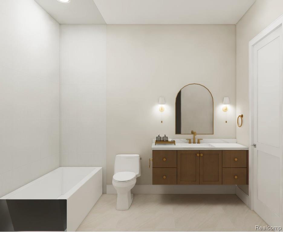 Bathroom with a white bathtub, toilet, and dark wood vanity with an arched mirror.