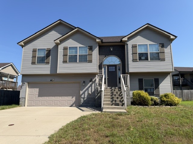 Two-story gray home with a two-car garage and arched central entry.