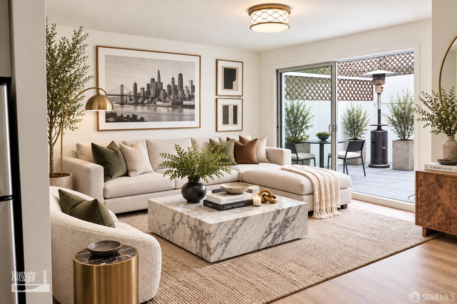 Staged living room with a cream sectional, marble coffee table, and sliding doors to a private patio.