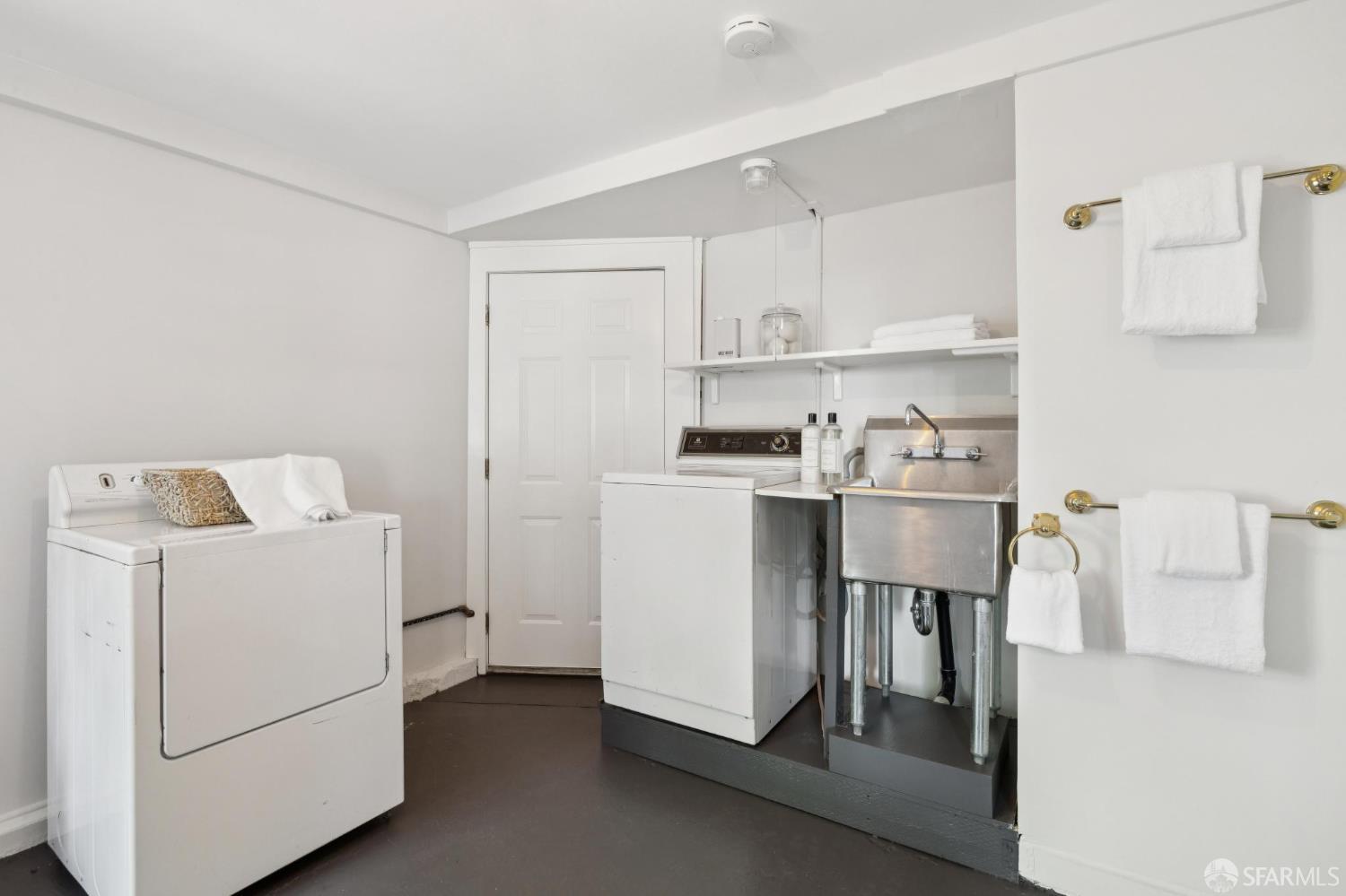 Laundry room with washer, dryer, and stainless utility sink.
