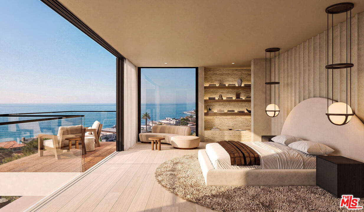 Modern bedroom with floor-to-ceiling windows overlooking the ocean and a balcony.