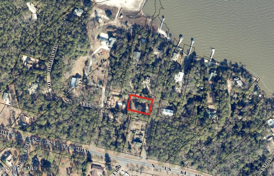 Wooded parcel outlined in red near US 64 and the waterfront.