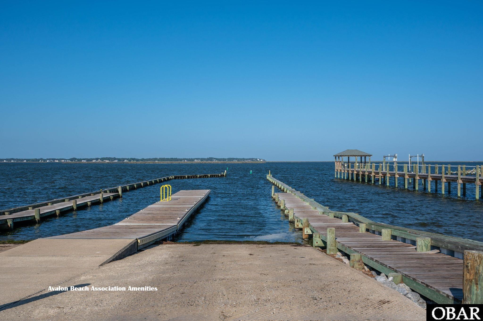 Waterfront docks extend into the water beside a covered pier pavilion.