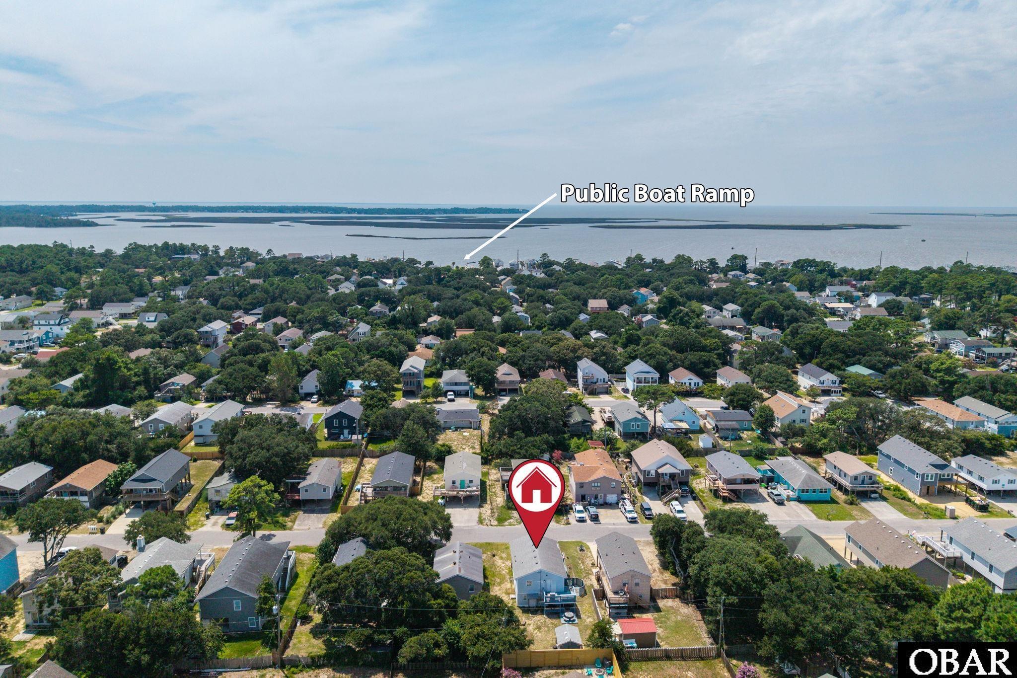Aerial view of a marked residential lot near the water and public boat ramp.
