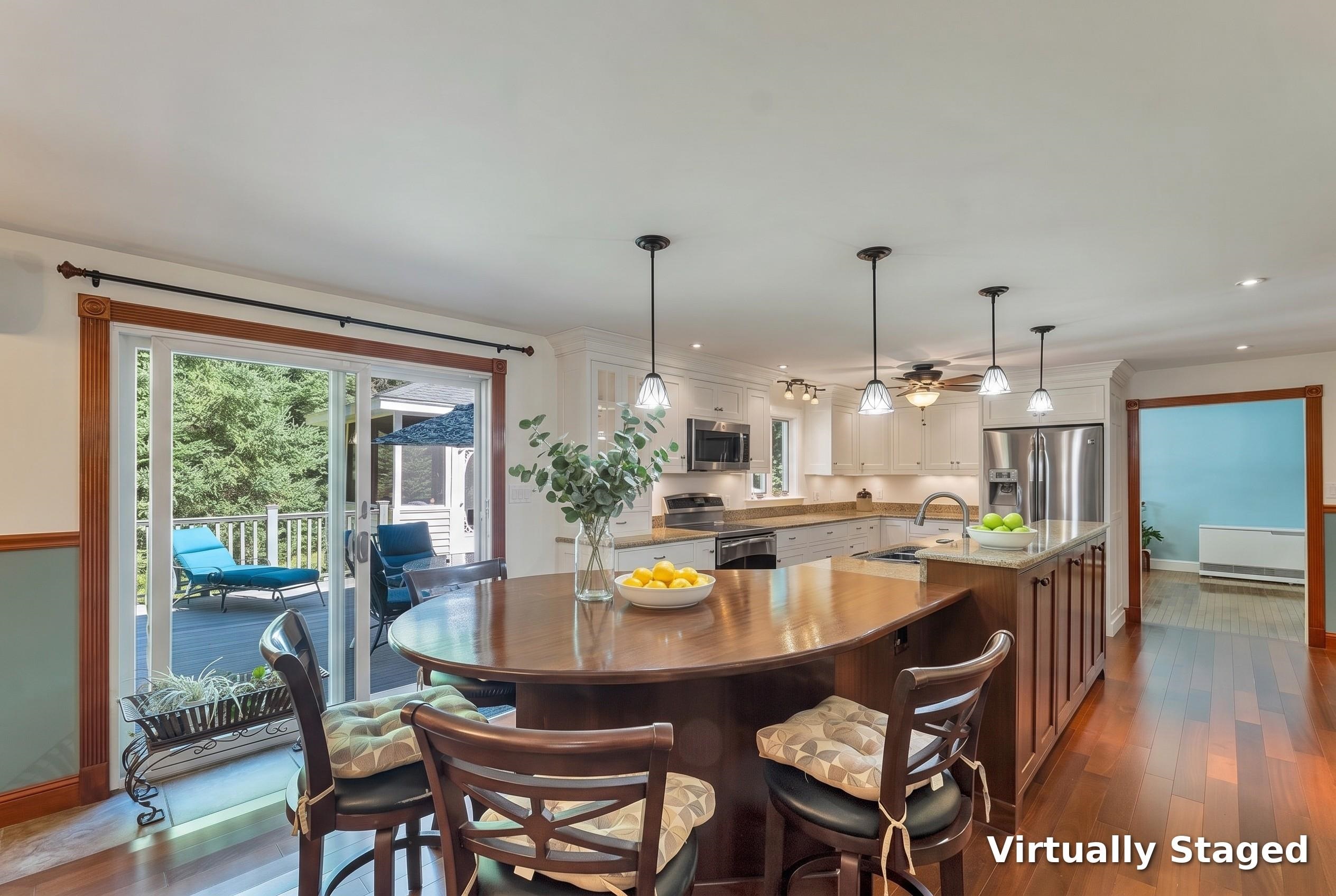 Kitchen and dining area with a large wood island, white cabinets, and sliding doors to a deck.