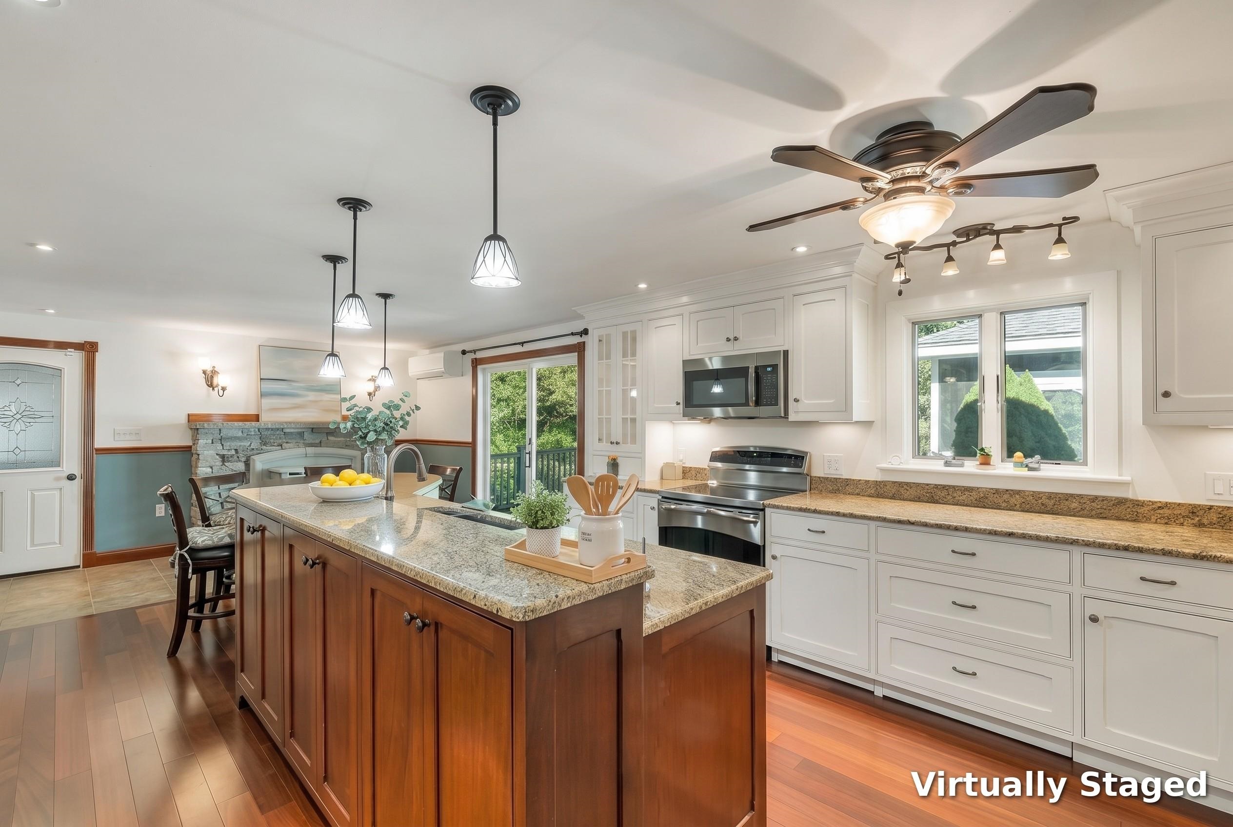 Kitchen with white cabinets, stainless appliances, granite counters, and a large wood island.