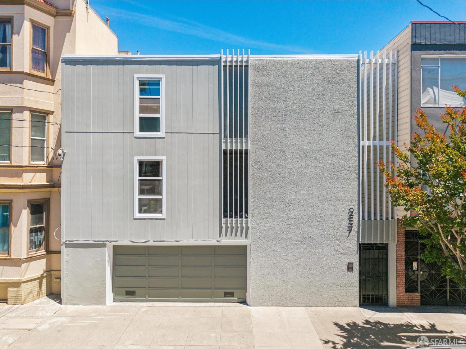 Modern gray home with a garage and vertical white slats, numbered 257.
