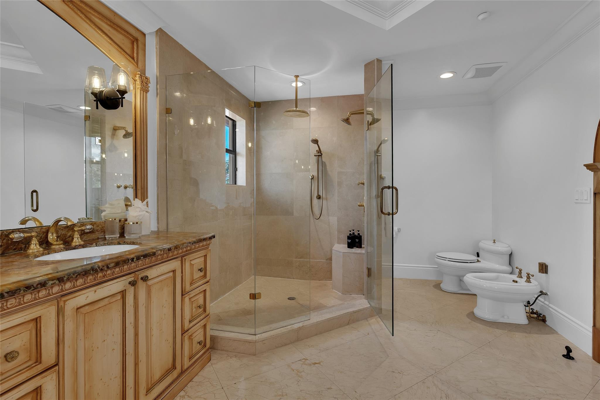 Bathroom with an ornate wood vanity and spacious glass-enclosed shower.