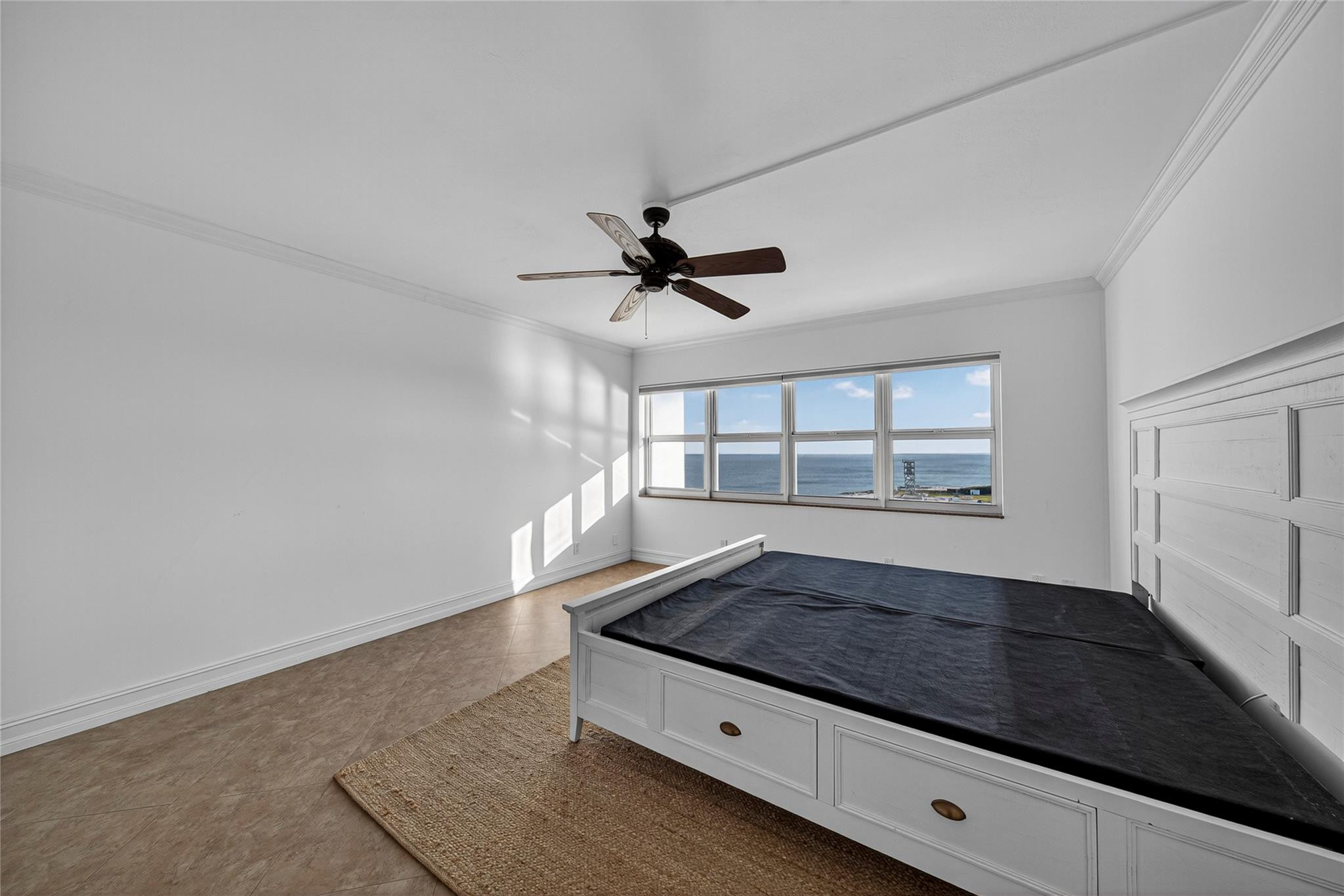 Bedroom with a built-in platform bed and a wide ocean-view window.