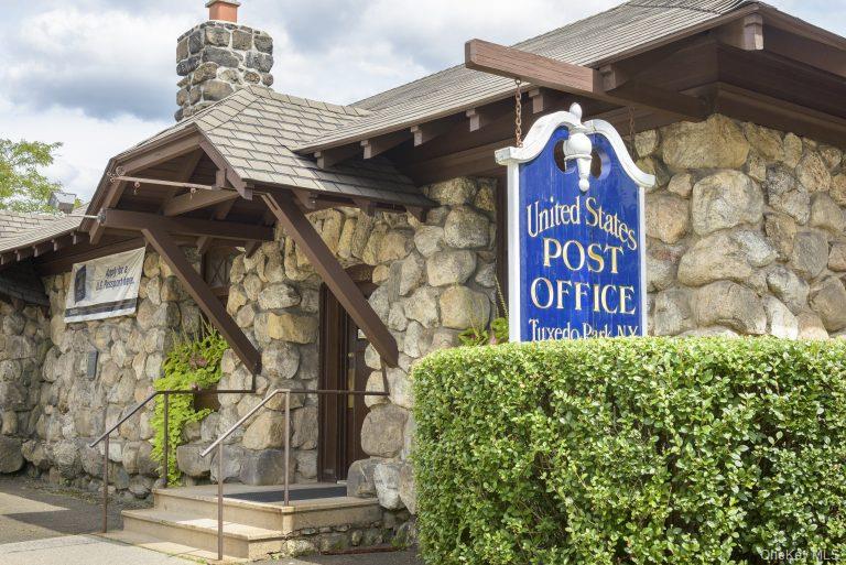 Tuxedo Park post office with stone walls and a blue United States Post Office sign.