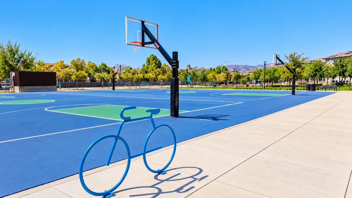 Outdoor basketball courts with multiple hoops and a blue bicycle-shaped rack beside the walkway.