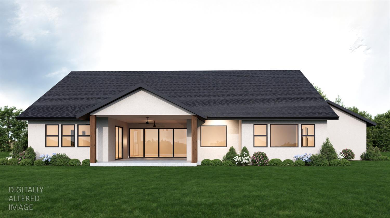 Rear exterior of a single-story home with a covered patio, large windows, and landscaped lawn.