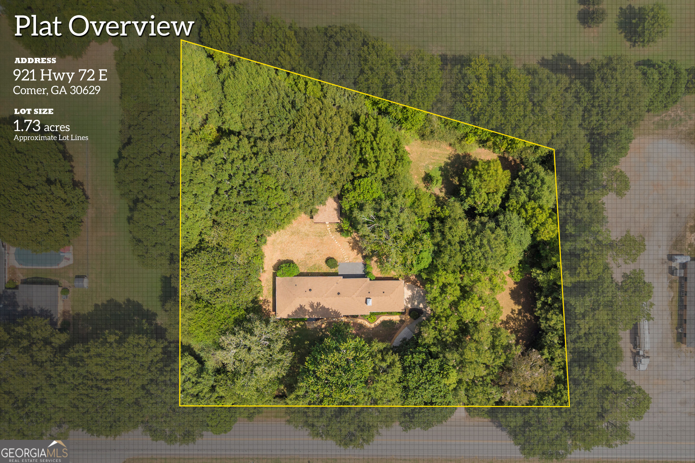 Aerial view of a wooded 1.73-acre property, outlined in yellow, with a house near the center.