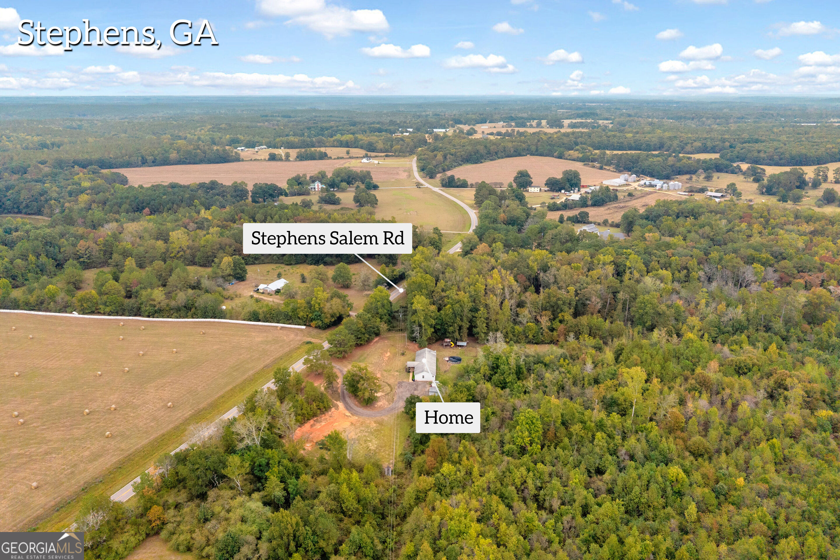 Aerial view of a rural home surrounded by woods and fields near Stephens Salem Road.