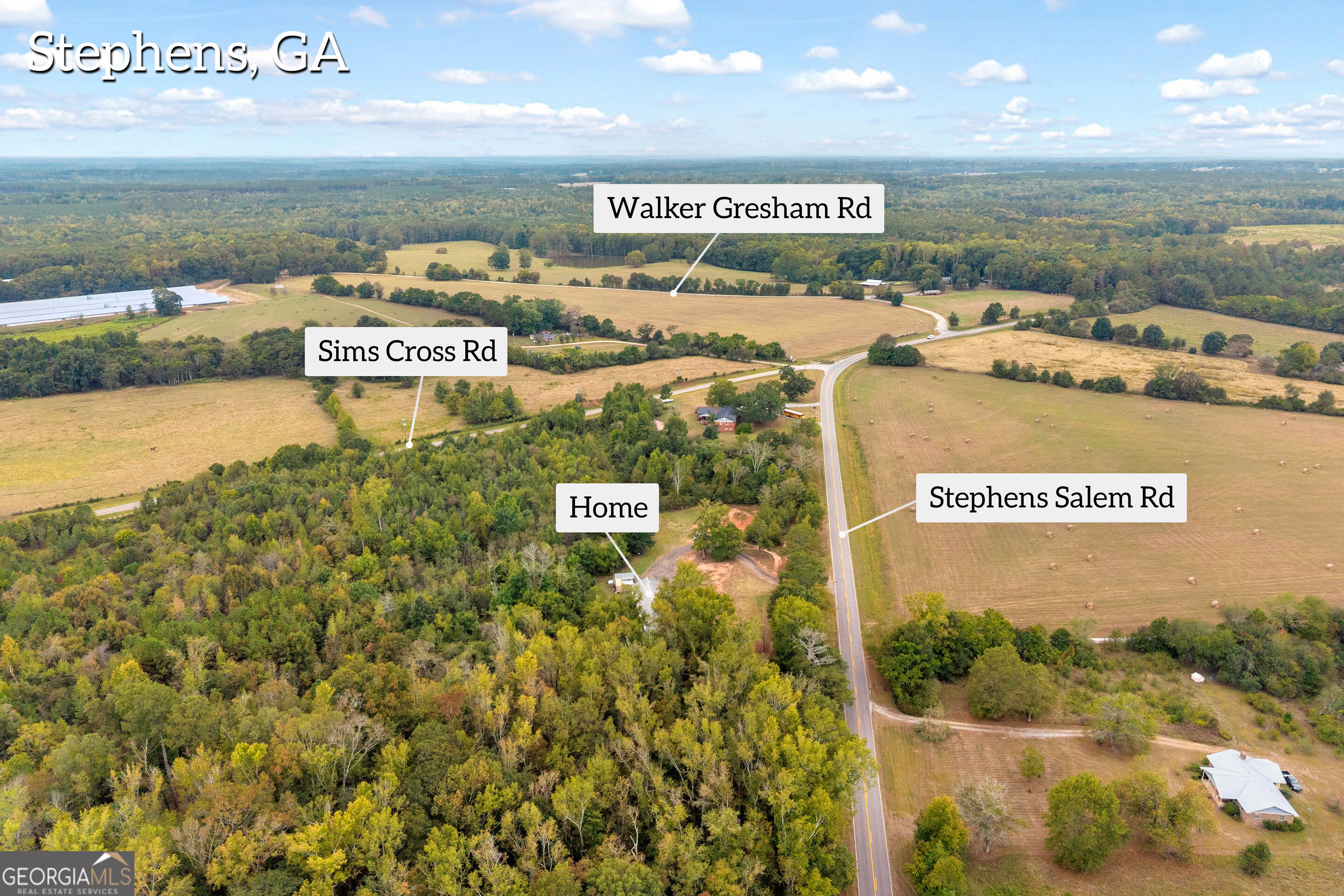 Aerial view of wooded rural property, with home near Stephens Salem Road and surrounding fields.