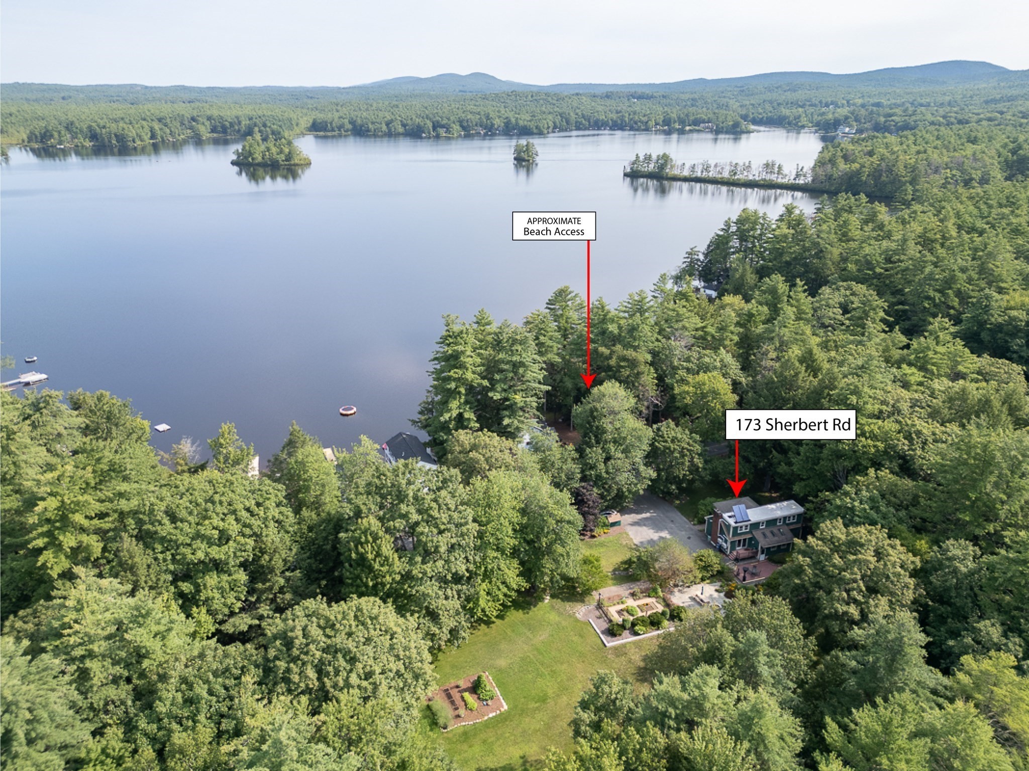 Aerial view of 173 Sherbert Rd beside a wooded lake, with approximate beach access marked.