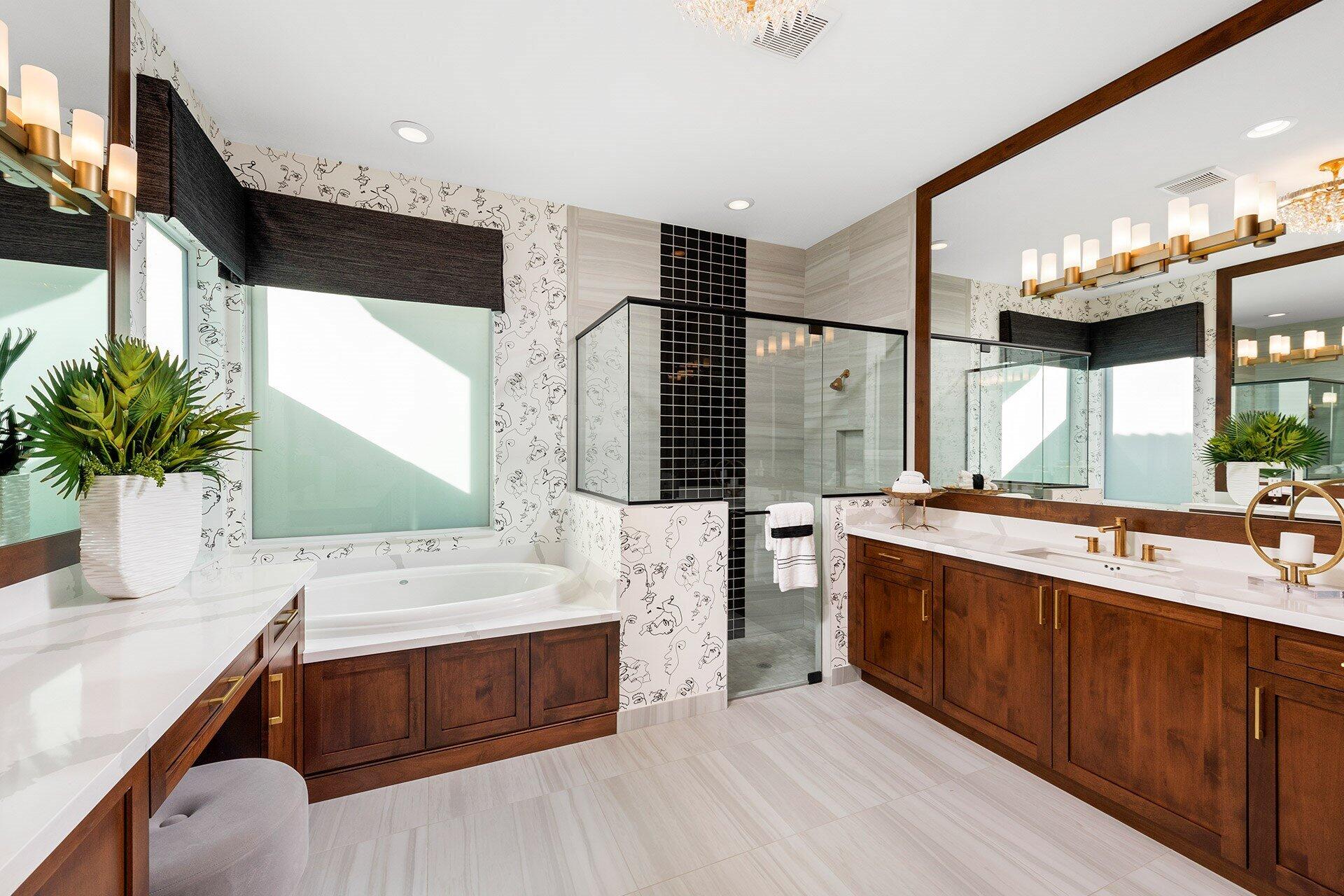 Primary bathroom with a soaking tub, glass shower, and dark wood double vanity.