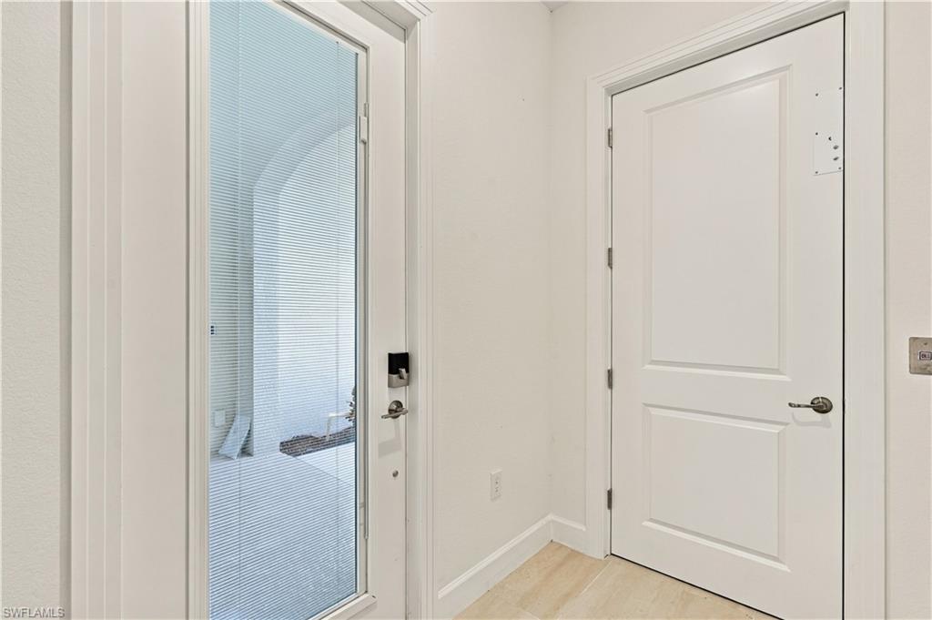 Entry foyer with a glass-panel exterior door and a separate white paneled door.