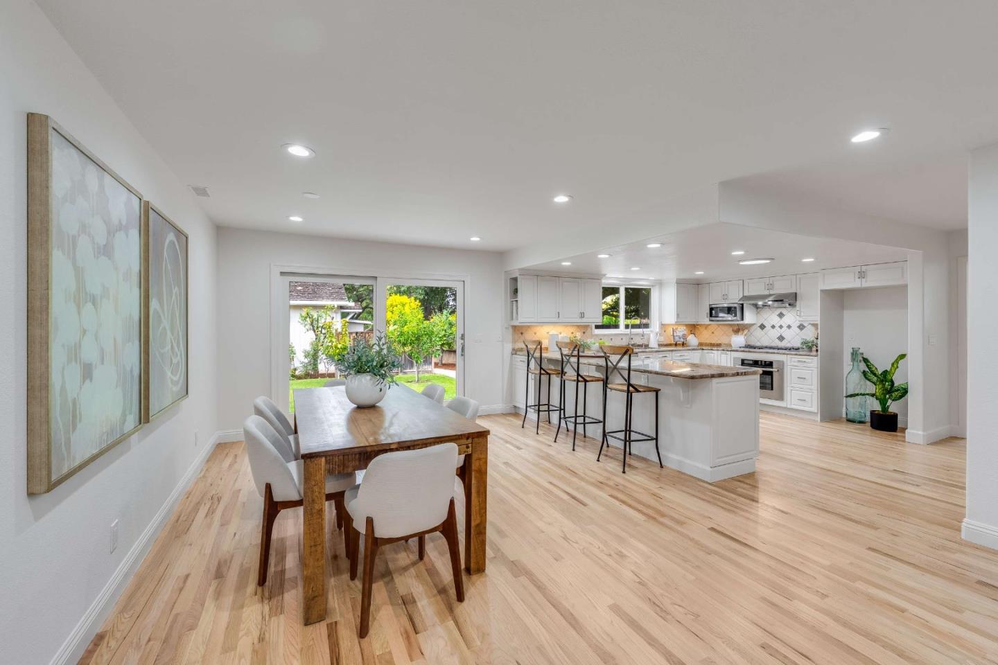 Open-plan kitchen and dining area with a large island and sliding doors to the backyard.
