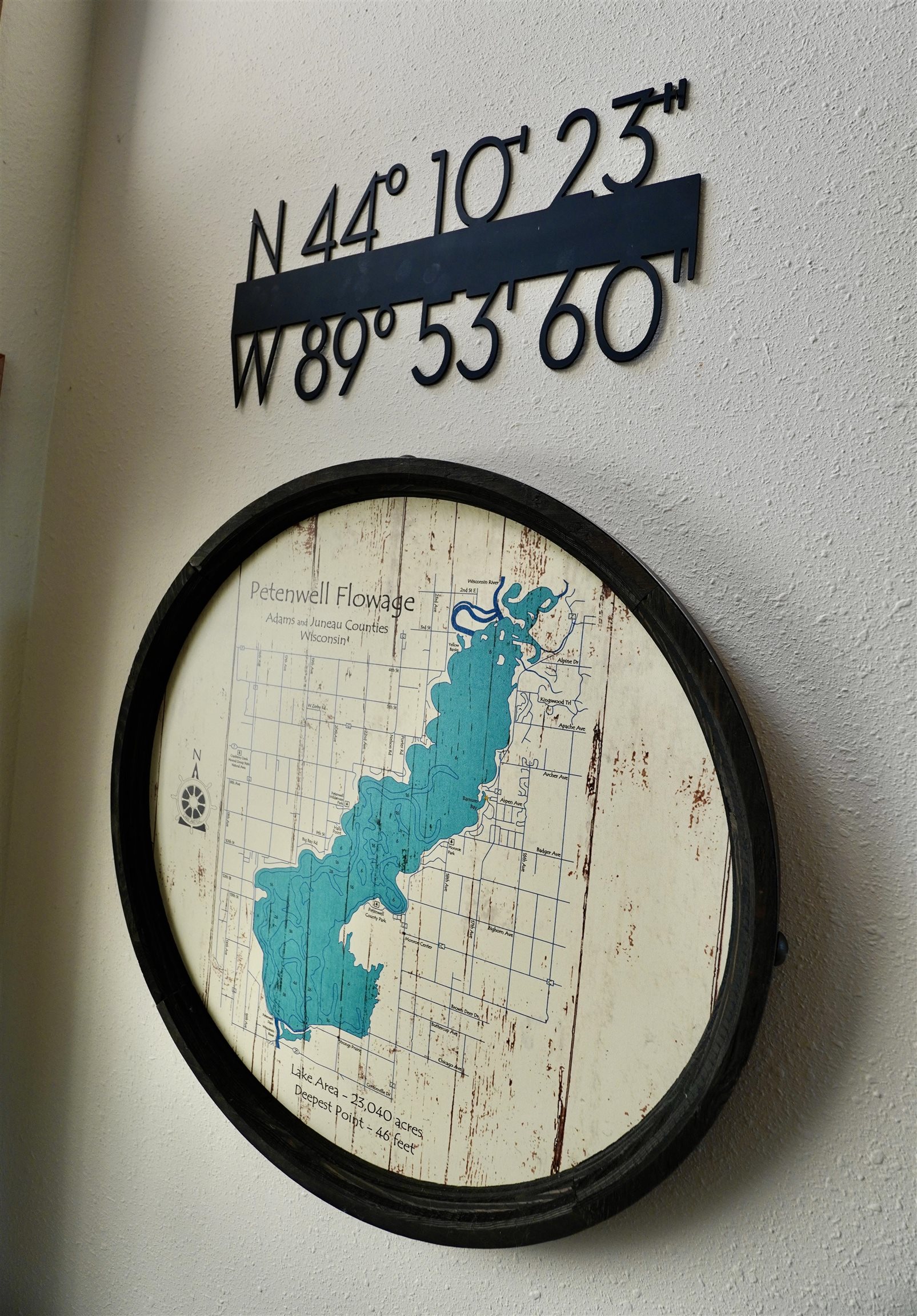 Framed Petenwell Flowage map with latitude and longitude coordinates displayed above it.