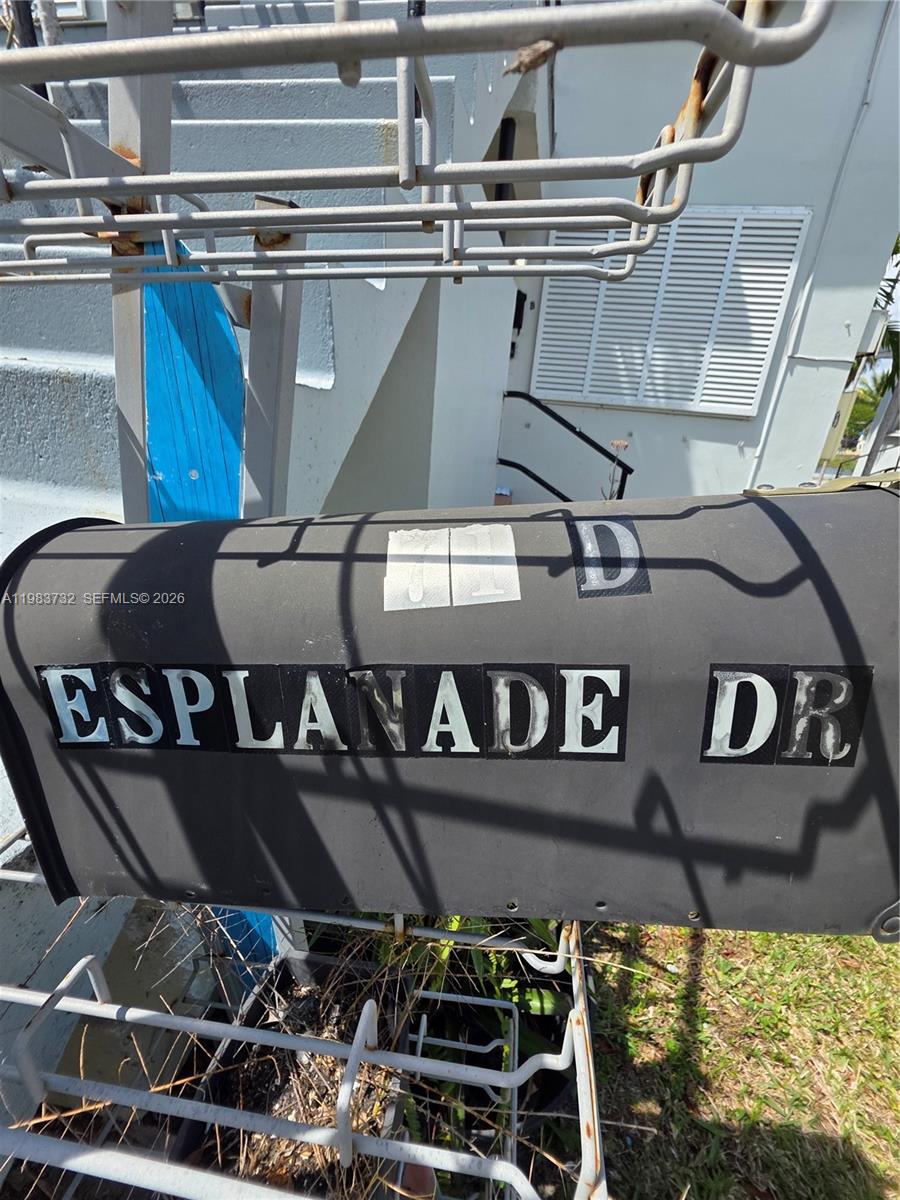 Mailbox marked Esplanade Dr beside an exterior stairwell.