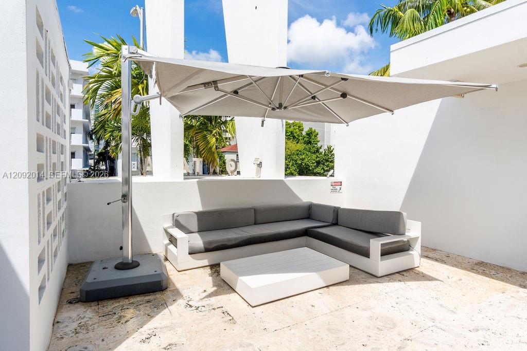 Outdoor patio with gray sectional seating and a large shade umbrella