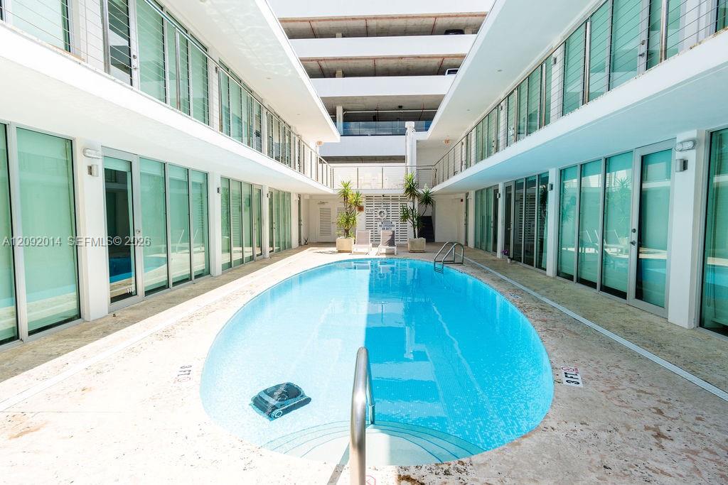 Courtyard swimming pool between modern condominium units.