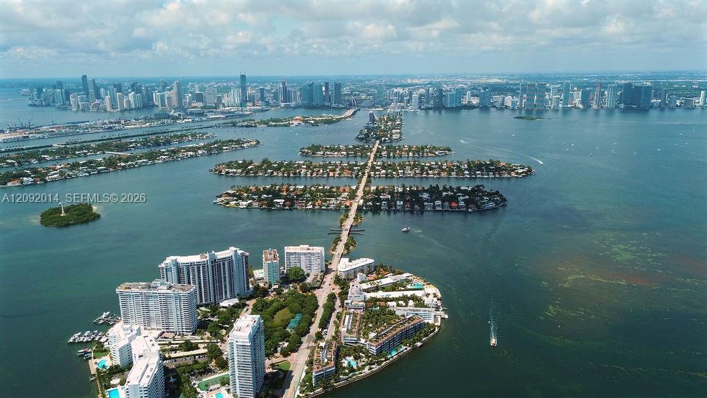 Aerial view across Biscayne Bay toward Miami’s skyline, with waterfront islands and high-rises in the foreground.