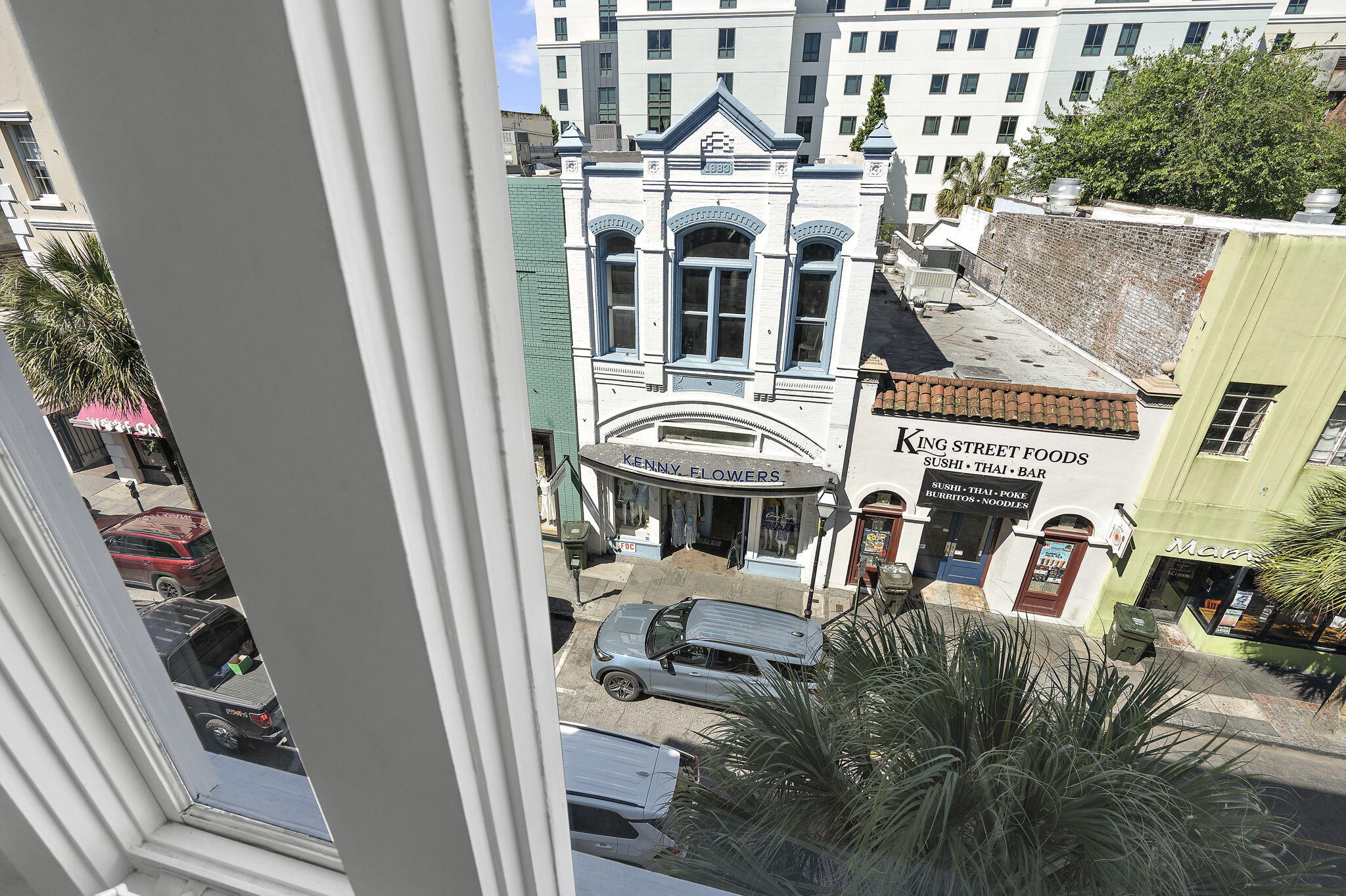 King Street storefronts seen from above, including the ornate Kenny Flowers facade and King Street Foods.