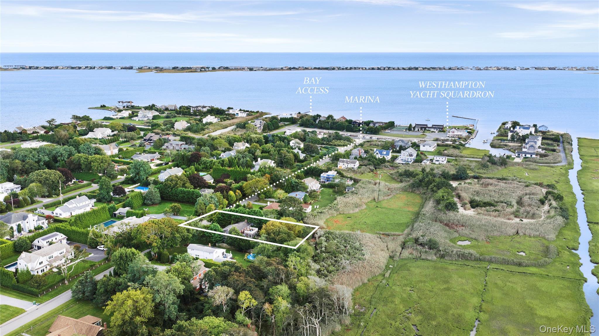 Aerial view of an outlined Westhampton Beach property near the bay, marina, and wetlands.