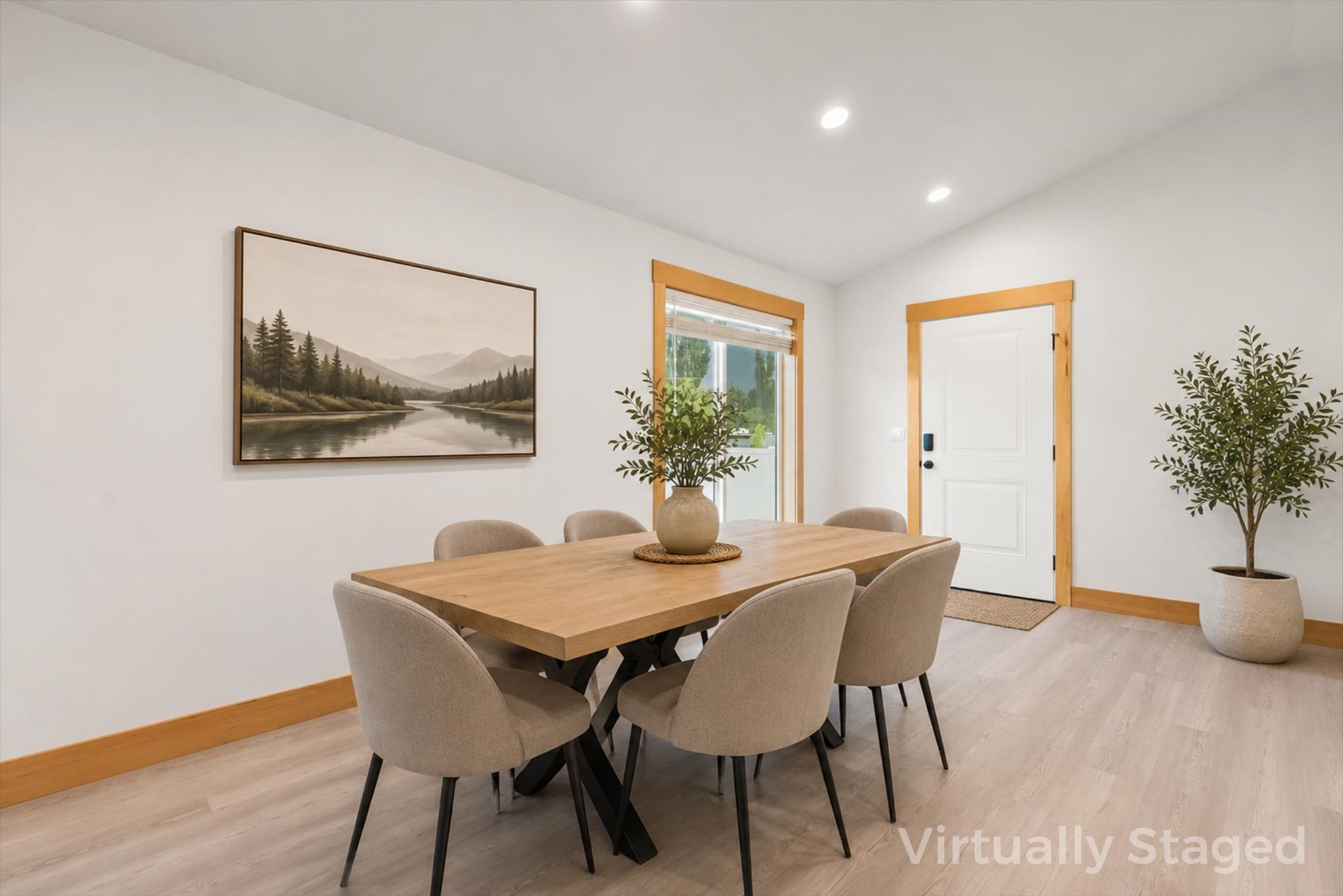 Virtually staged dining room with a wood table, upholstered chairs, and warm wood trim.