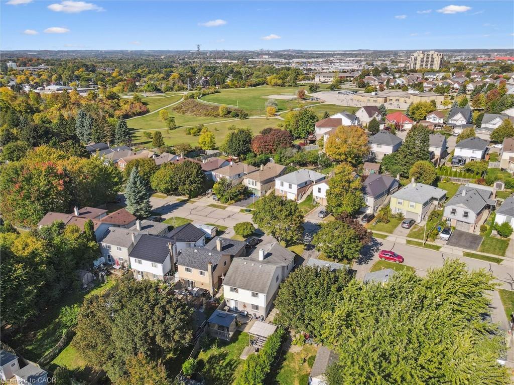 Aerial view of a residential neighborhood beside a large green park.