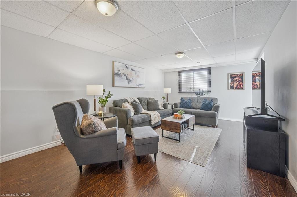 Furnished living room with gray seating, a wood coffee table, and hardwood floors.