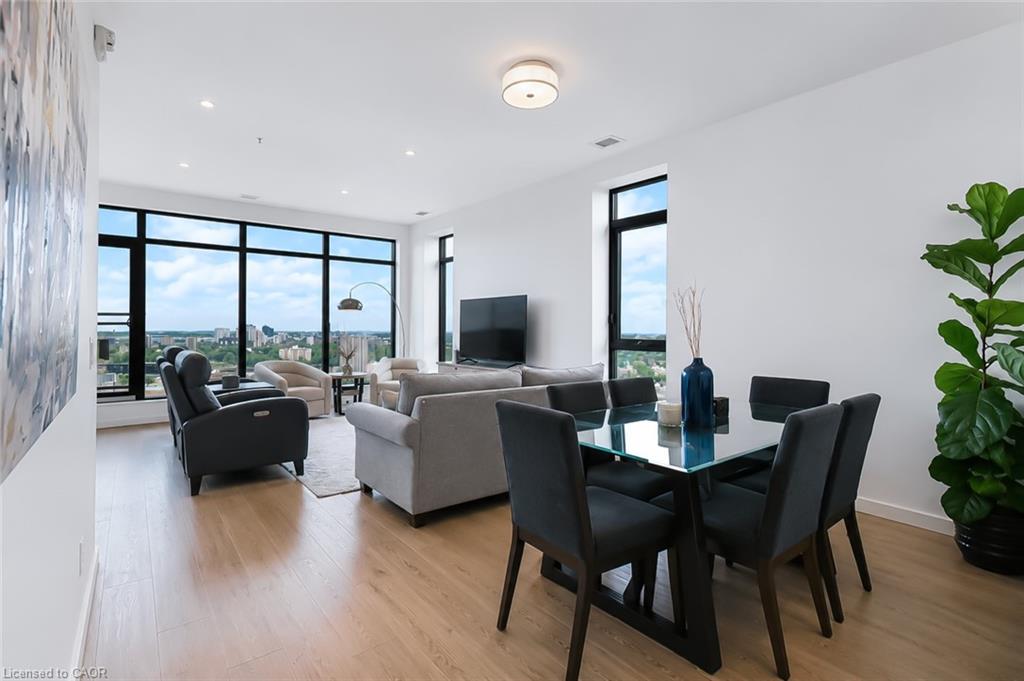 Open-plan condo living and dining room with floor-to-ceiling windows and a Waterloo city view.