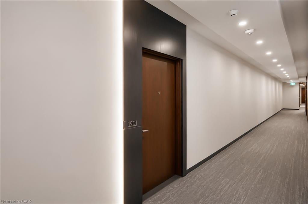 Condominium hallway with the dark wood door to unit 1901.