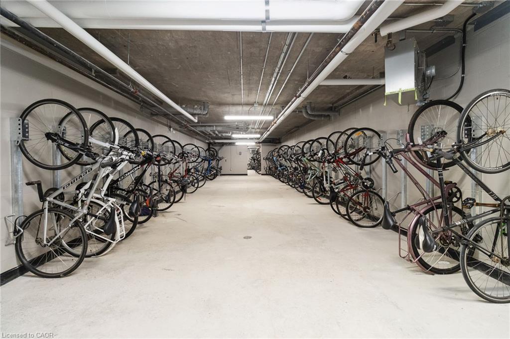 Condominium bicycle storage room with rows of bikes lining both walls.