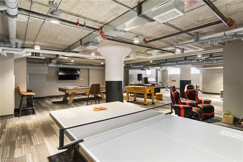 Condo recreation room with ping-pong tables, a pool table, and gaming chairs.