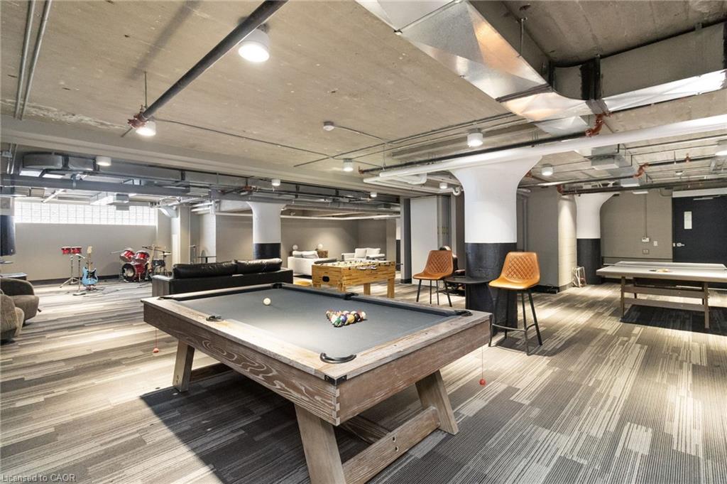 Building recreation room with a pool table, ping-pong table, and seating.