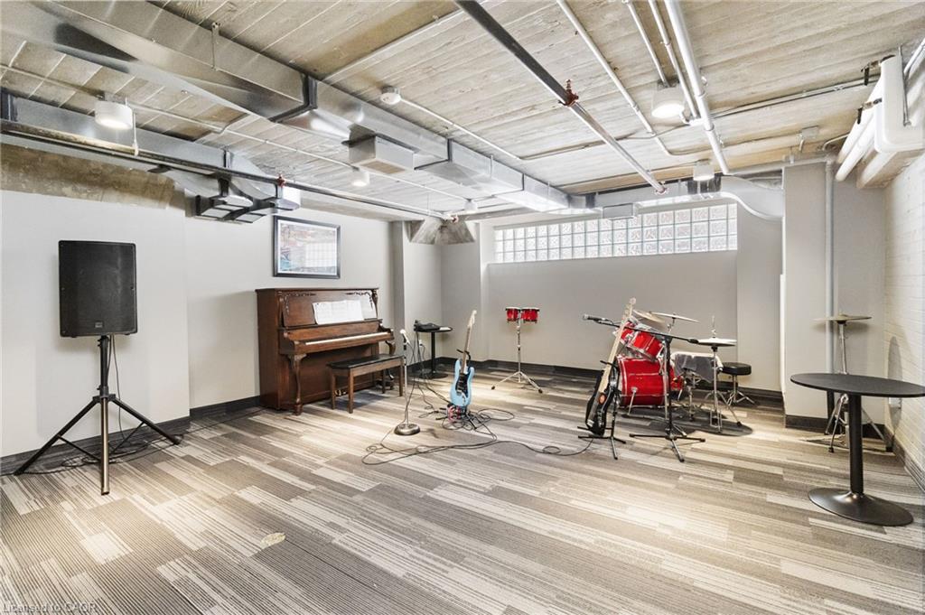 Shared music room with piano, guitars, drum kit, and sound equipment.
